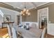 Bright dining room with coffered ceiling, decorative chandelier, and wainscoting at 5600 Bennettwood Ct, Raleigh, NC 27612
