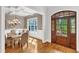 Elegant dining room featuring a wooden table, chandelier, and natural light at 5600 Bennettwood Ct, Raleigh, NC 27612
