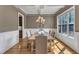 Cozy dining room with a chandelier and a view of the well landscaped yard at 5600 Bennettwood Ct, Raleigh, NC 27612