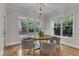Bright dining room featuring hardwood floors, a round table with seating for four, and plenty of natural light at 5600 Bennettwood Ct, Raleigh, NC 27612