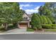 Charming home with a stone and brick facade, a two-car garage, and lush landscaping at 5600 Bennettwood Ct, Raleigh, NC 27612