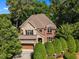 Beautiful brick and stone home with mature trees and manicured landscaping at 5600 Bennettwood Ct, Raleigh, NC 27612