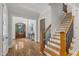 Grand foyer with hardwood floors, staircase, and an elegant entry door at 5600 Bennettwood Ct, Raleigh, NC 27612