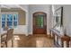 Bright foyer with hardwood floors, a decorative front door, and wainscoting at 5600 Bennettwood Ct, Raleigh, NC 27612