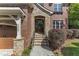 Inviting brick and stone front entrance with a covered porch and stone steps at 5600 Bennettwood Ct, Raleigh, NC 27612