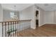 Bright hallway with hardwood floors, chandelier, and view overlooking the first floor at 5600 Bennettwood Ct, Raleigh, NC 27612