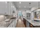 Modern kitchen with stainless steel appliances and a view to a dining area at 5600 Bennettwood Ct, Raleigh, NC 27612