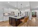 Spacious kitchen with a dark wood island, white cabinets, and stainless steel appliances at 5600 Bennettwood Ct, Raleigh, NC 27612