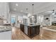 Modern kitchen featuring stainless steel appliances, white cabinets, and a large kitchen island at 5600 Bennettwood Ct, Raleigh, NC 27612