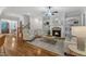 Cozy living room featuring a fireplace with stone surround and custom built-in shelving at 5600 Bennettwood Ct, Raleigh, NC 27612