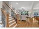 Inviting living room with stairs, hardwood floors, fireplace, and lots of natural light at 5600 Bennettwood Ct, Raleigh, NC 27612