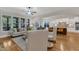 Bright living room with large windows, connecting to a dining area and modern kitchen at 5600 Bennettwood Ct, Raleigh, NC 27612