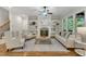 Inviting living room with a fireplace, built-in bookshelves and lots of natural light at 5600 Bennettwood Ct, Raleigh, NC 27612