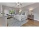 Comfortable bedroom with a ceiling fan, decorative rug, and bright natural light at 5600 Bennettwood Ct, Raleigh, NC 27612