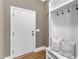 Welcoming mudroom with built-in bench, coat hooks, and shoe storage near the front door at 5600 Bennettwood Ct, Raleigh, NC 27612