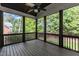 This screened porch features a ceiling fan and views of the surrounding greenery at 5600 Bennettwood Ct, Raleigh, NC 27612