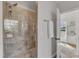 Tiled shower with a glass door, shower head, and built-in bench at 5600 Bennettwood Ct, Raleigh, NC 27612
