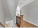 Upstairs hallway boasts hardwood floors and staircase with decorative rails at 5600 Bennettwood Ct, Raleigh, NC 27612