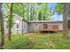 View of the backyard showing a deck, house exterior and treed landscape at 5613 Deerborn Dr, Apex, NC 27539