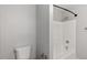 Clean bathroom featuring white shower and toilet with neutral walls at 5613 Deerborn Dr, Apex, NC 27539