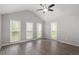 Spacious primary bedroom with vaulted ceiling, fan and large windows allowing natural light at 5613 Deerborn Dr, Apex, NC 27539