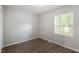 Bedroom features a window bringing natural light and vinyl flooring throughout at 5613 Deerborn Dr, Apex, NC 27539