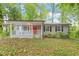 Charming single-story home showcasing a welcoming front porch and vibrant red front door at 5613 Deerborn Dr, Apex, NC 27539