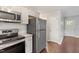 Modern kitchen featuring stainless steel appliances, granite countertops and a sleek black range at 5613 Deerborn Dr, Apex, NC 27539