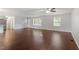 Bright living space with wood floors, ceiling fan, and large windows offering plenty of natural light at 5613 Deerborn Dr, Apex, NC 27539