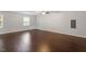 Expansive living room featuring hardwood floors and abundant natural light with modern ceiling fan at 5613 Deerborn Dr, Apex, NC 27539