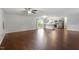 Open-concept living area with wood floors seamlessly connects to the kitchen and dining space at 5613 Deerborn Dr, Apex, NC 27539