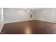 Spacious living room featuring sleek wood floors, neutral walls, and a modern ceiling fan at 5613 Deerborn Dr, Apex, NC 27539