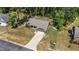 An aerial view shows the property's manicured lawn, driveway, inviting porch, deck and proximity to lush trees at 60 Northdale Ct, Louisburg, NC 27549