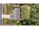 Aerial view of home showcasing large backyard with wooden deck and play structure, plus driveway and landscaping at 60 Northdale Ct, Louisburg, NC 27549