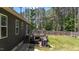 A backyard oasis features a wooden deck ideal for entertaining, with a grill and a beautiful green lawn at 60 Northdale Ct, Louisburg, NC 27549