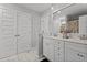 Bright bathroom featuring a double vanity, stylish mirror and modern fixtures at 60 Northdale Ct, Louisburg, NC 27549