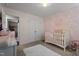 Charming Bedroom with a floral wallpaper, white crib, and decorative accents at 60 Northdale Ct, Louisburg, NC 27549