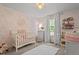 Charming Bedroom with a floral wallpaper, white crib, and decorative accents at 60 Northdale Ct, Louisburg, NC 27549