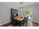 Bright dining area with wooden table, backyard access, and elegant chandelier lighting at 60 Northdale Ct, Louisburg, NC 27549