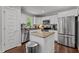 Modern kitchen with white cabinets, stainless steel appliances, and central island with granite countertops at 60 Northdale Ct, Louisburg, NC 27549