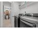 Laundry room featuring modern washer and dryer units, plus extra storage at 60 Northdale Ct, Louisburg, NC 27549