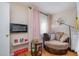 Comfortable bedroom space with a round couch, modern lighting, and stylish decor at 629 Pine Ridge Pl, Raleigh, NC 27609