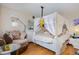 Cozy bedroom featuring a unique canopy bed and comfortable seating area at 629 Pine Ridge Pl, Raleigh, NC 27609