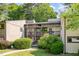 Exterior of a two-story condo unit with wood siding, screened porches, and landscaped walkway and lawn at 629 Pine Ridge Pl, Raleigh, NC 27609