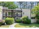 Exterior of a two-story condo unit with wood siding, screened porches, and landscaped walkway and lawn at 629 Pine Ridge Pl, Raleigh, NC 27609