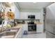 Bright kitchen featuring stainless steel appliances and white cabinetry at 629 Pine Ridge Pl, Raleigh, NC 27609
