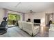 Living room features a reclining sofa, ceiling fan, and sliding glass doors to an outdoor porch at 629 Pine Ridge Pl, Raleigh, NC 27609