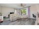 Living room offers a ceiling fan, recliner sofa, love seat, a glass coffee table and an outdoor porch at 629 Pine Ridge Pl, Raleigh, NC 27609