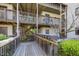 Wood walkway leading to upper level units; mailboxes shown on the right of the walkway at 629 Pine Ridge Pl, Raleigh, NC 27609