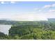 Scenic aerial view showcasing the home's location amidst a beautiful landscape of trees and a shimmering lake at 7116 Incline Dr, Wake Forest, NC 27587